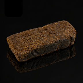 Bloc de résine CHARAS CBD 22–24 % brun foncé sur fond noir | SUPRHEMP